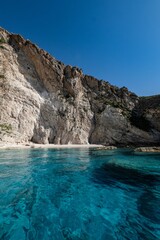 Fototapeta premium Vertical view of the coastal cliffs and the serene water of the Ionian sea in Zakynthos, Greece