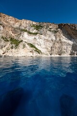 Vertical view of the coastal cliffs and the tranquil water of the Ionian sea in Zakynthos, Greece