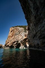 Vertical view of the coastal cliffs and the tranquil water of the Ionian sea in Zakynthos, Greece