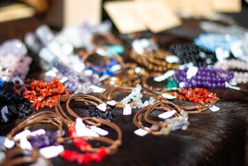 Handmade gemstone necklaces displayed at an outdoor market