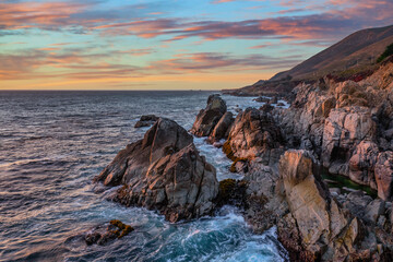 Obraz premium Beautiful landscape of Pacific Ocean coast along Highway 1 and Big Sur, aerial view, sunset, sunrise, fog. Concept, travel, vacation, weekend