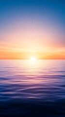 Fototapeta premium Beautiful sunrise over calm ocean water, showcasing vibrant colorful sky and tranquil sea. Perfect for backgrounds and inspirational uses.