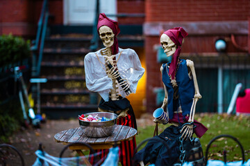 Halloween house outdoor decorations with skeleton, pumpkins and ghosts near the Halloween house porch. Halloween pumpkin and skeleton for decorated house. Halloween yard of a home, Trick or treat.