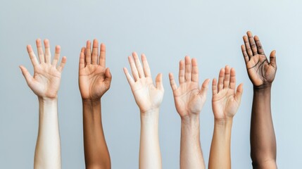 Obraz premium Diverse Hands Raised in Unity Showing a Variety of Skin Tones