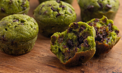 Healthy Green Spinach Hidden Vegi Chocolate Chip Mini Muffins on a Wooden Table