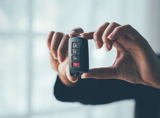 Keys to Success: A businesswoman holds up a car key, symbolizing new beginnings, achievement, and the open road of opportunity. 