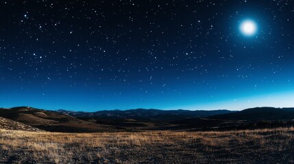 Fototapeta premium A clear night sky with a bright full moon and scattered stars, casting a gentle glow over the landscape.
