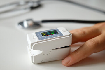 Unrecognizable woman monitoring blood oxygen level using digital fingertip oximeter to measure her pulse and saturation ensuring proper health care during routine medical checkup