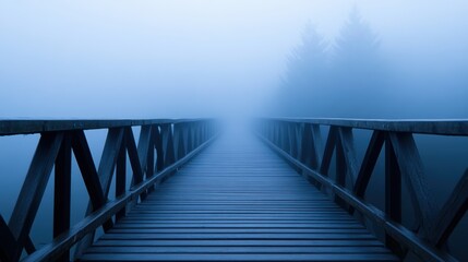 Fototapeta premium A tranquil scene of a wooden bridge disappearing into a thick blue fog, inviting exploration and reflection in nature's embrace.