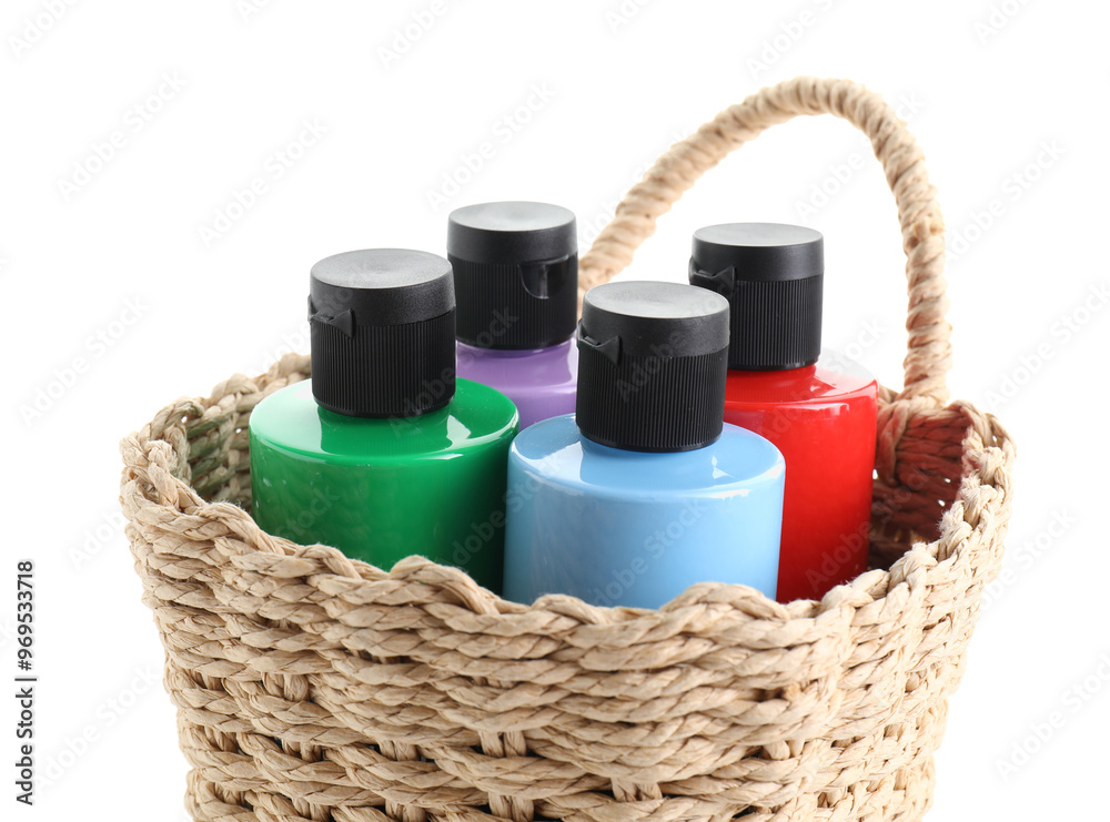 Canvas Prints Bottled acrylic paints of different colors in wicker basket isolated on white