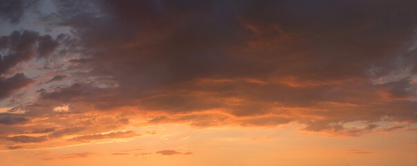 colorful sunset sky with orange dust and grey clouds