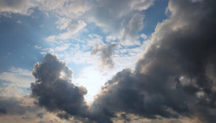 the sun breaks through grey clouds after a heavy thunderstorm