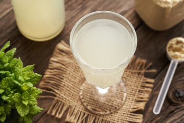 Fresh natural whey in a glass and whey protein powder