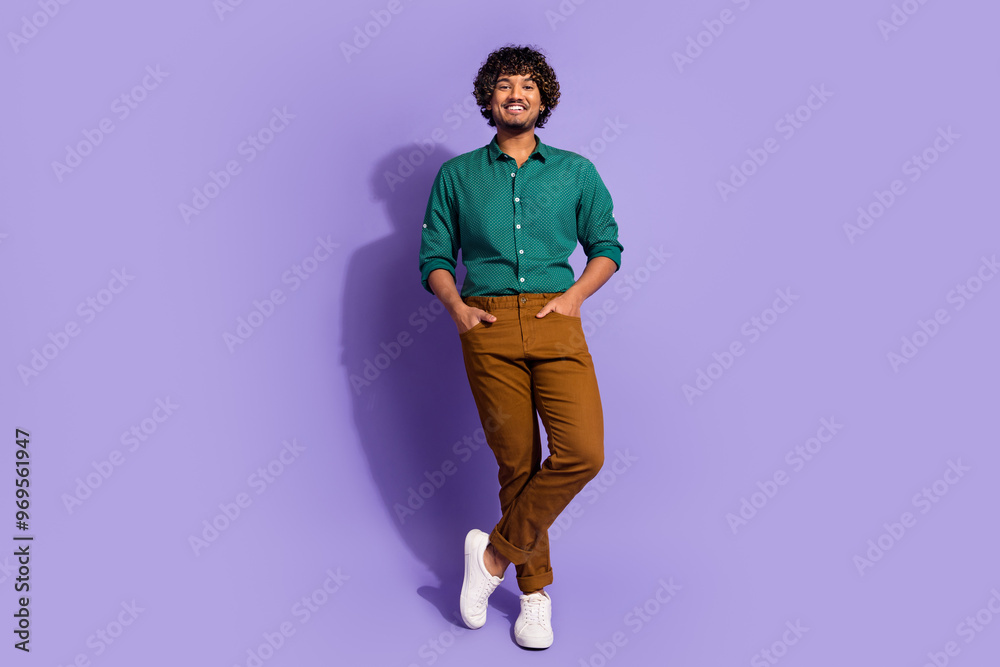 Wall mural Photo portrait of funny latin businessman with wavy haircut wearing green casual shirt isolated on violet color background