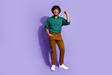 Fototapeta premium Photo portrait of funny arabian businessman with curly hair in casual outfit raised fist up champion isolated on violet color background