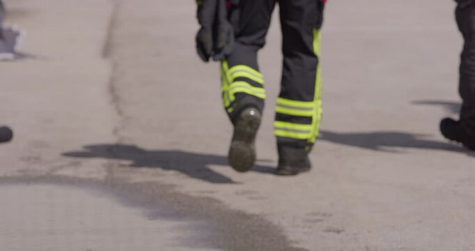 The reflection in water reveals a team of specially equipped firefighters coordinating and embarking on a high-risk, life-saving mission to rescue people in distress, showcasing their unwavering