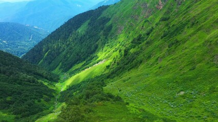 Obraz premium Lush Green Mountainous Landscape with Valleys and Slopes