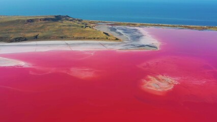 Vibrant Pink Lake Adjacent to Blue-Green Waters