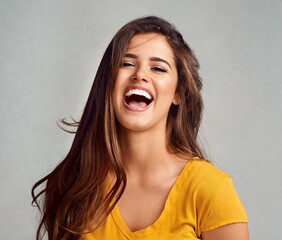 Studio, laugh and portrait of woman with confidence, positive attitude and comedy in trendy fashion. Happy, face and girl in gen z style with pride, funny joke and cheerful on grey background