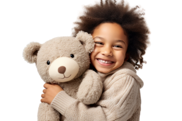 A smiling child holding a large stuffed animal, hugging it tightly while wearing a cozy sweater isolated on white background