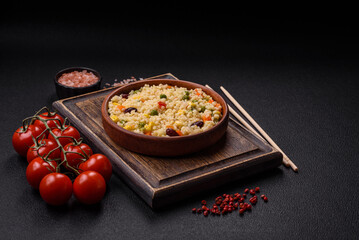 Boiled wheat bulgur porridge with vegetables peppers, peas, corn