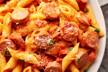 Homemade One-Pot Hot Dog Pasta on a Plate, top view. Flat lay, from above. Close-up.