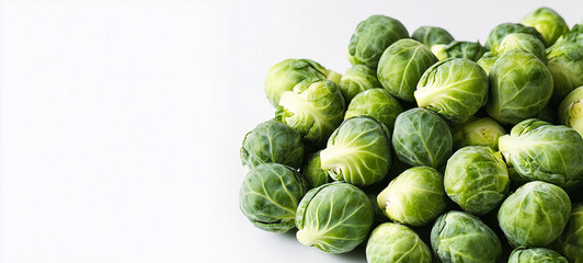 Fototapeta premium Pile of fresh Brussels sprouts on a white background