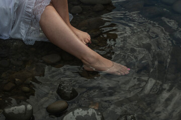 Woman's legs dipping into the water