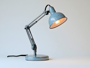 Sleek and modern aluminum desk lamp with an adjustable neck isolated against a clean white background This versatile lighting fixture is perfect for illuminating a workspace desk or study area
