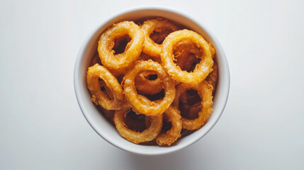 A bowl filled with crispy onion rings, photographed from above against a plain white backdrop.