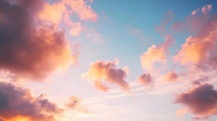 Obraz premium A serene sunset sky filled with vibrant clouds, showcasing shades of pink and orange against a light background