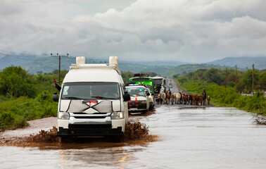 Vehicles drive through flood waters in Southern Ethiopia during flooding monsoon rains in 2024.