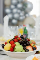 Fruit bowl with strawberries, cherries, apples, and peaches.