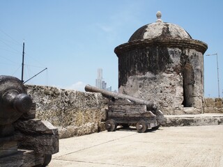 Historic cannons and stone turret at Cartagena city walls © Wirestock