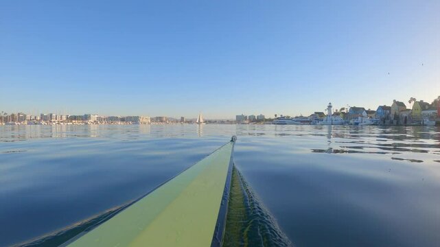 Rowing boat POV as it races on the water on a crisp beautiful morning.