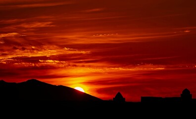 Silhouette stunning Vista of ancient cisterns with mountain and red sunset sky