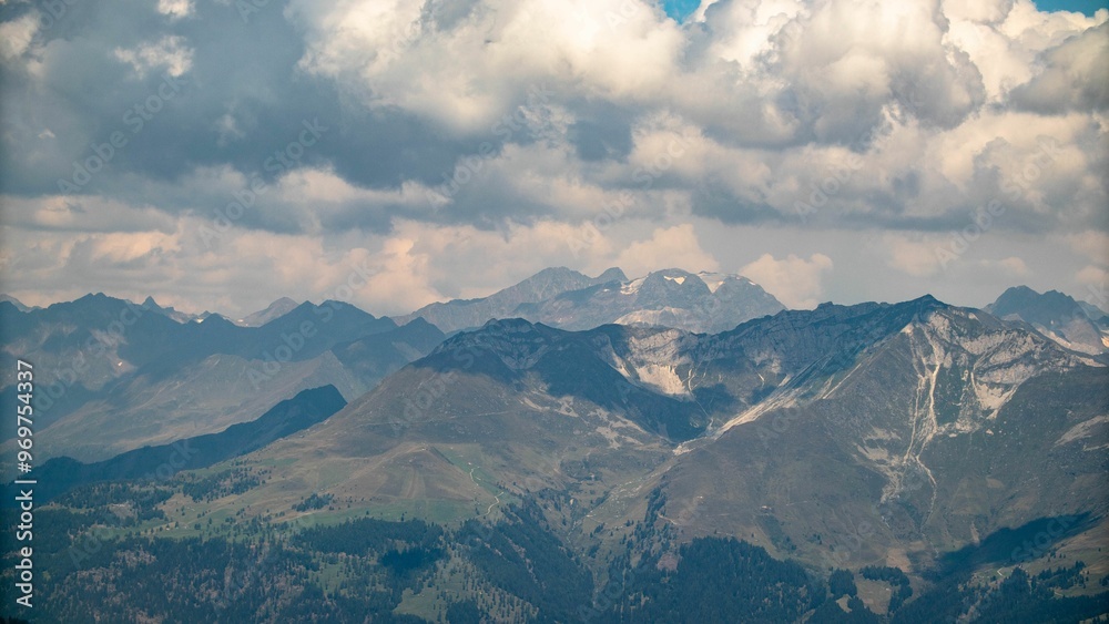 Wall mural Scenic view of the Alps mountains under a cloudy sky