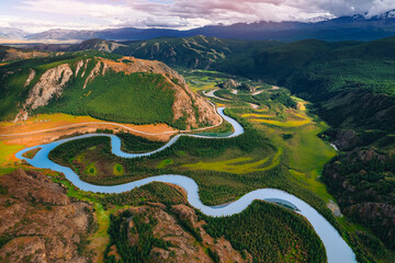 Landscape Altai with winding River meander in mountains with forest trees, aerial top view