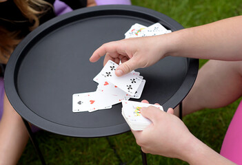 family playing cards outdoors. Board games
