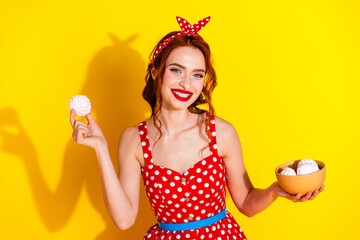 Photo of adorable positive lady wear red stylish clothes hand hold tasty zephyr isolated on yellow...