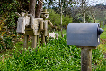 Wood garden figures in New Zealand's countryside