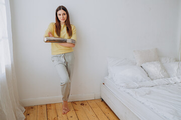 Woman with metal prosthetic arm bionic hand, dressed in casual clothes and displaying calm...
