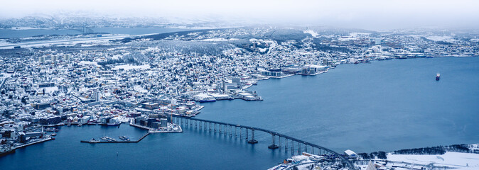 A panorama wide shot of the harbour city of Tromsø, Norway, in winter.
