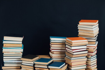 lots of stacks of old vintage books to study in the library on a black background