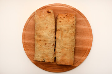 Meat shawarma on a cutting board. Burritos with meat.