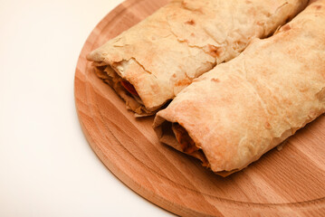 Meat shawarma on a cutting board. Burritos with meat.