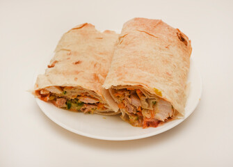 Meat shawarma on a white plate. Burritos with meat.