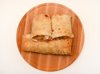 Meat shawarma on a cutting board. Burritos with meat.