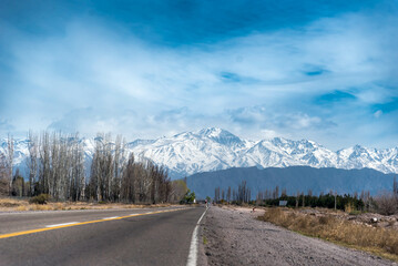 landscape of route and snowy mountains, with a wonderful blue sky