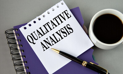 QUALITATIVE ANALYSIS - words on a white sheet with a cup of coffee